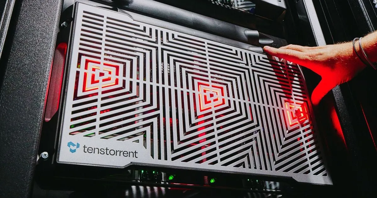 Tenstorrent server hardware with a geometric metal faceplate, lit red, in a data centre rack.